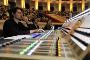 an audio board with an A1 mixing sounds at a live event